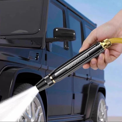 URBANOMAX high-pressure water spray nozzle attached to garden hose, showcasing durable metal construction for powerful cleaning.