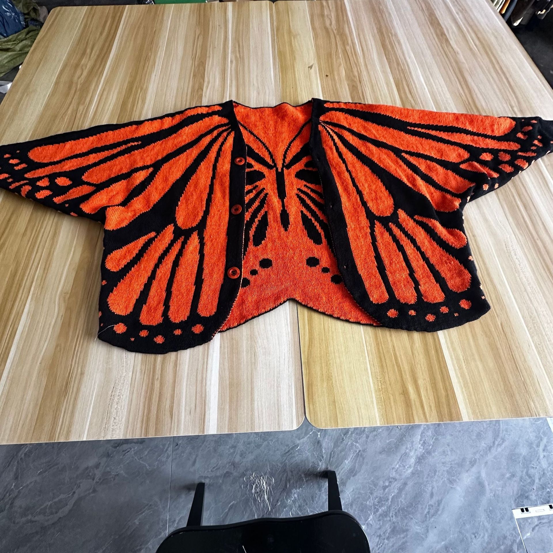 Christmas Monarch Butterfly Knit Cardigan featuring festive holiday design, cozy knit fabric, and detailed butterfly pattern.
