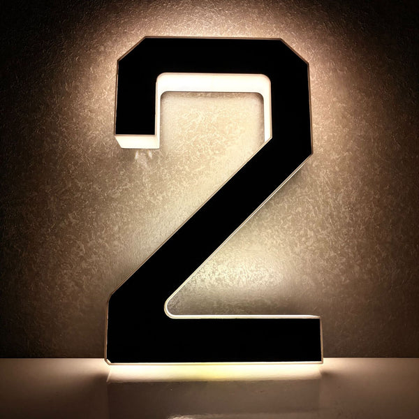 Urbanomax solar-powered digital house number plate with Christmas design, illuminated display for outdoor home identification.