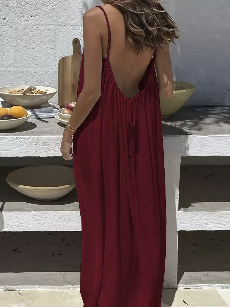 URBANOMAX backless maxi dress with adjustable straps, flowing fabric, and elegant design suitable for home wear or casual occasions.